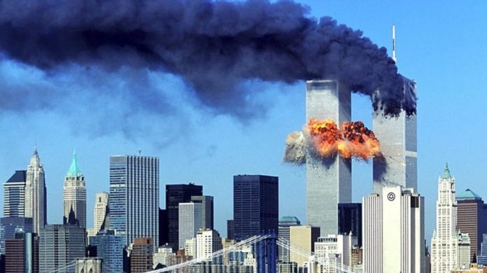 the_twin_towers_moments_after_being_hit_by_the_two_planes-696x390