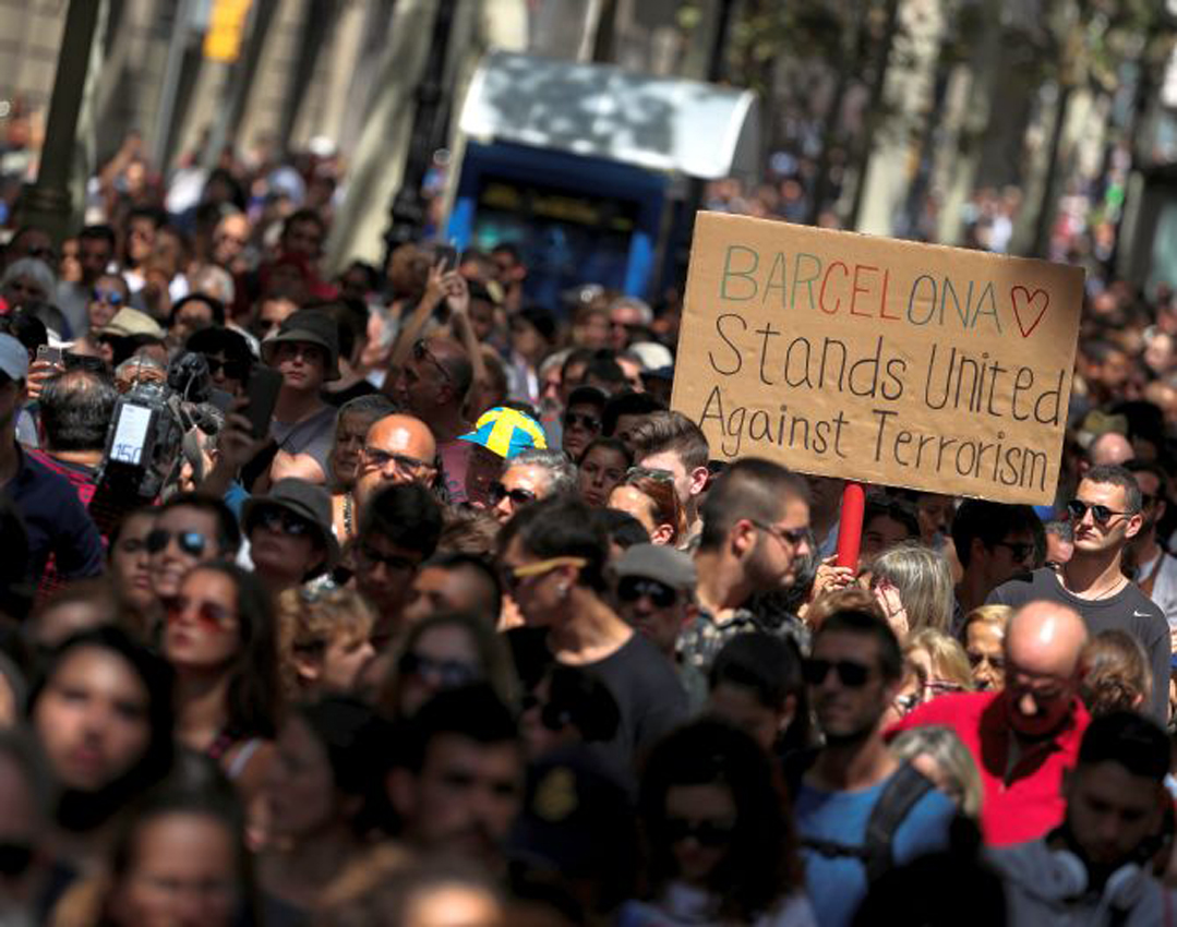 People march down Las Ramblas the day after a van crashed into pedestrians in Barcelona