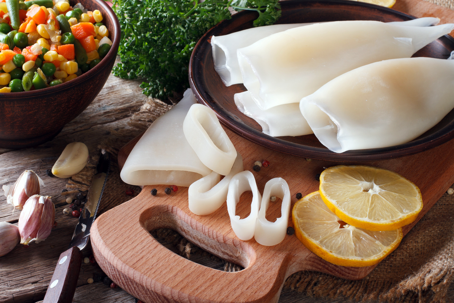 Preparation of raw squid and ingredients close-up. Horizontal