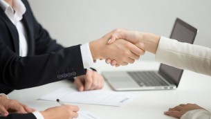 Hr handshaking successful candidate getting hired at new job, closeup