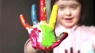 Cute girl with painted hand