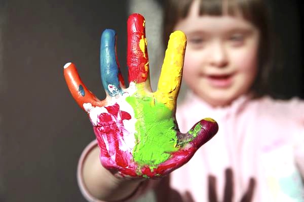 Cute girl with painted hand